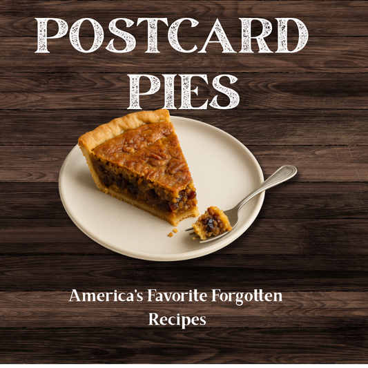 Postcard of 'Postcard Pies' with a slice of pie on a plate against a wooden background